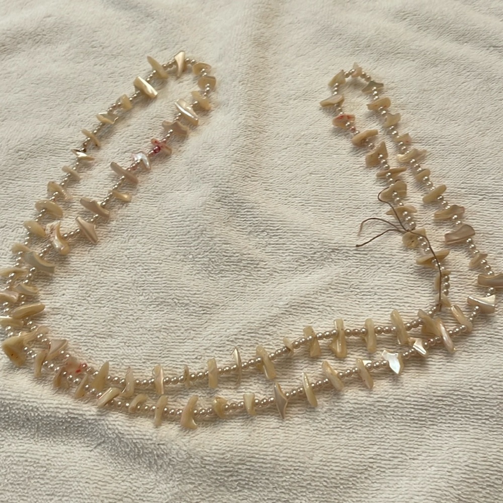 22 inch mother of pearl necklace. No clasp needs cleaning: item as is.